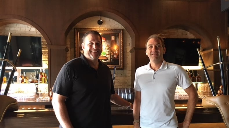 Paul Kennel (left) and Marty Brown, owners of Timothy’s bar, 1818 Brown St., since 1996, upstairs in their Double 18 Lounge, which they opened last year. THOMAS GNAU/STAFF