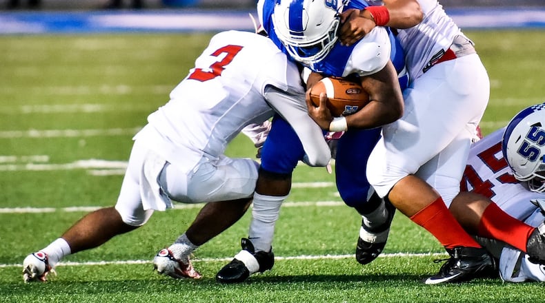 Hamilton’s Maleek Jarrett carries the ball during Friday night’s game against Princeton at Virgil Schwarm Stadium in Hamilton. NICK GRAHAM/STAFF