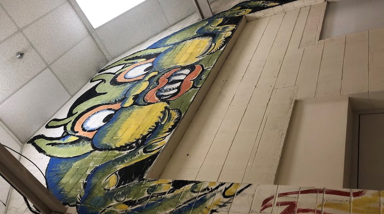 German prisoners of war housed in Dayton during World War II painted these cartoonish figures that are on a wall in a building at Wright-Patterson Air Force Base. Some of the artwork was destroyed decades ago. These paintings were restored in the 1980s, but some now are worried about if they will be preserved for future generations. CONTRIBUTED