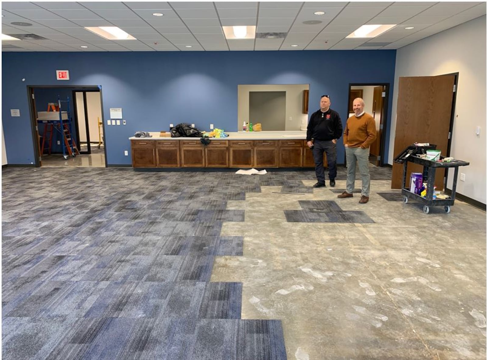 Lebanon Fire & EMS Chief Steven Johnson, left, and City Manager Scott Brunka look over the flooring installation in the conference room at Station 41. The new facility will help the department with training activities as well as being available for community events. ED RICHTER/STAFF