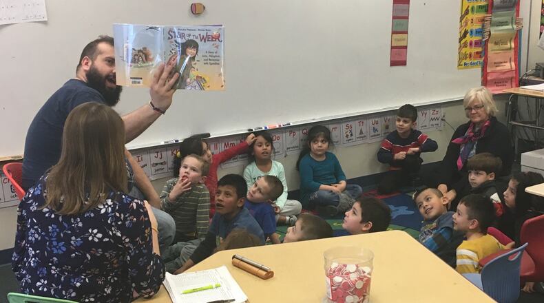 Jason McIntosh works with kindergarten students at Ruskin Elementary in Dayton, as part of East End Community Services’ after-school Miracle Makers program. JEREMY P. KELLEY / STAFF