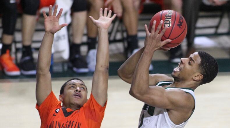 Ohio’s Jaaron Simmons shoots over Bowling Green and Wayne grad Rodrick Caldwell in a February game at the Convocation Center in Athens. David Jablonski/Staff