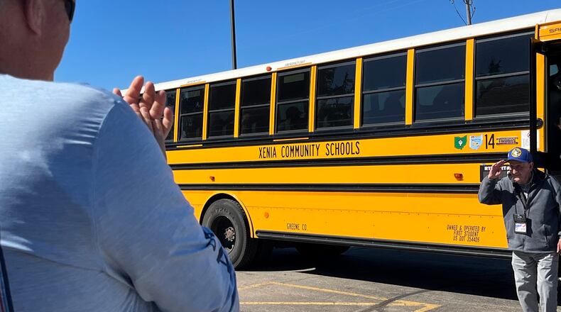 Airmen from the Springfield Air National Guard Base applaud as Walt DeWalt, an Army veteran who supported the Berlin Airlift as a mechanic, exits a bus at Young's Jersey Dairy in Clark County. A group of Airlift veterans and their families visited both the Springfield base and the dairy Friday. THOMAS GNAU/STAFF