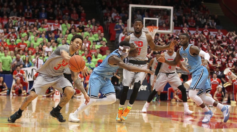 Dayton’s Kyle Davis, left, steals the ball from Rhode Island’s Jarvis Garrett and scores on Saturday, Feb. 27, 2016, at UD Arena in Dayton. David Jablonski/Staff