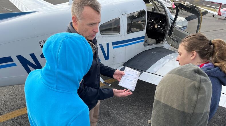 Flight instructor Tom Casey reviews a pre-flight checklist with students at an Air Camp session at the Lewis Jackson Airport in Xenia on Nov. 5. THOMAS GNAU/STAFF