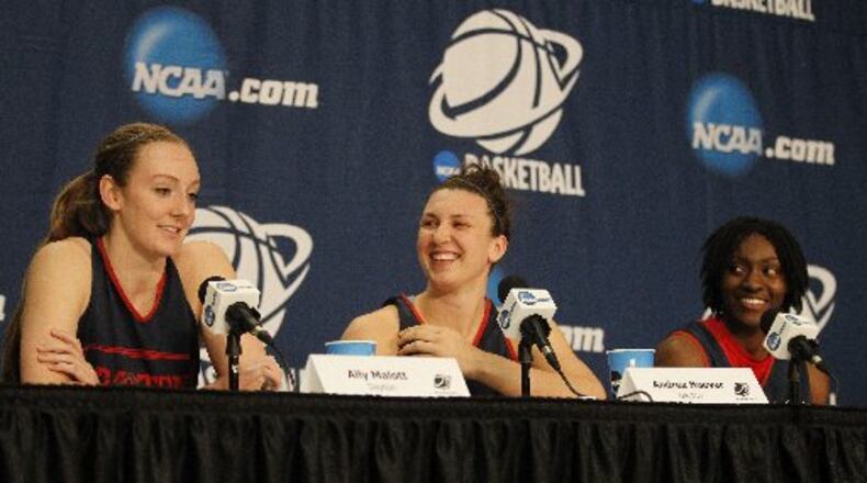 Dayton seniors Ally Malott, left, Andrea Hoover, center, and Tiffany Johnson laugh at a question during a press conference before practice on Friday, March 27, 2015, at the Times Union Center in Albany, N.Y. David Jablonski/Staff