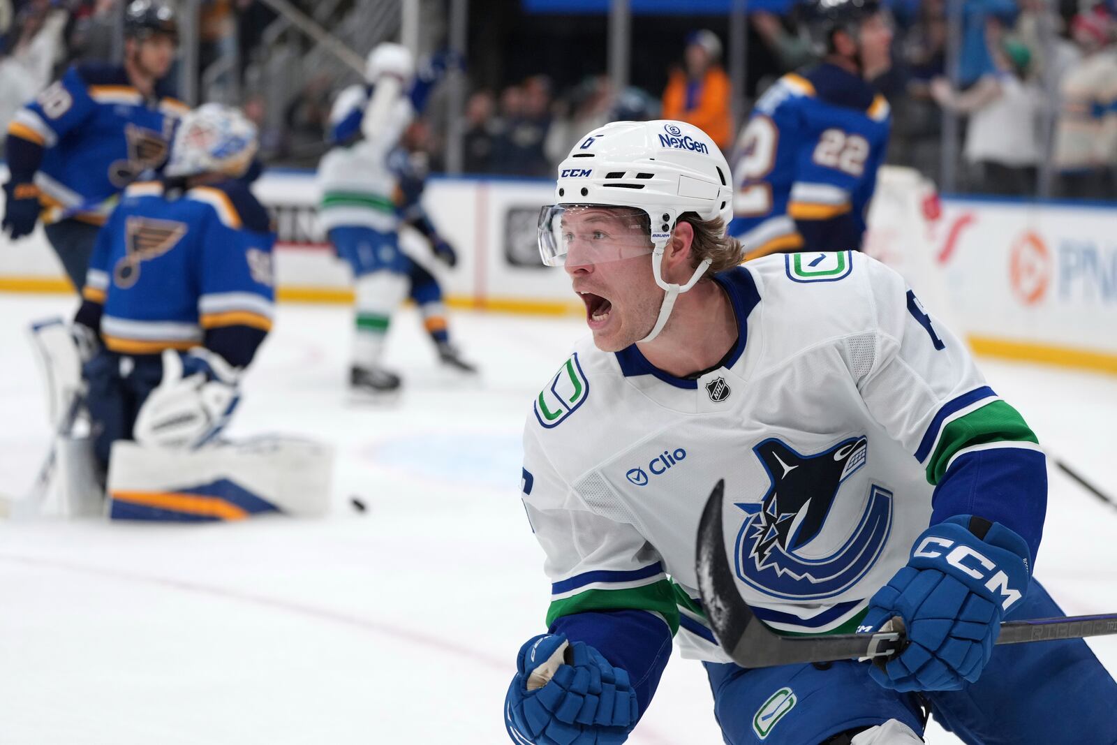 FILE - Vancouver Canucks' Brock Boeser, right, celebrates after scoring past St. Louis Blues goaltender Jordan Binnington, left, during the third period of an NHL hockey game, March 20, 2025, in St. Louis. (AP Photo/Jeff Roberson, file)