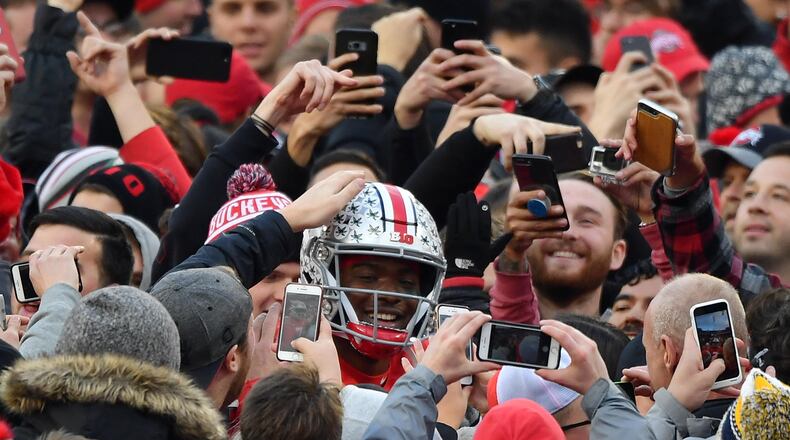 COLUMBUS, OH - NOVEMBER 24: Quarterback Dwayne Haskins #7 of the Ohio State Buckeyes is congratulated by fans as he walks off the field after defeating the Michigan Wolverines at Ohio Stadium on November 24, 2018 in Columbus, Ohio. Ohio State defeated Michigan 62-39. (Photo by Jamie Sabau/Getty Images)