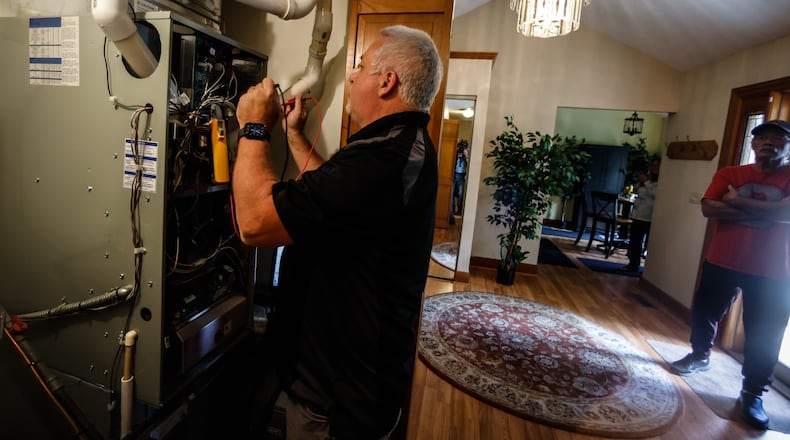Field Service Supervisor for Logan A/C and Heat Services, Bill Wireman services Bon and Brenda Anthony's home near Casstown Friday September 23, 2022. The average cost of home heating is estimated to increase from $1,025 last winter to $1,202 this winter, according to projections from the National Energy Assistance Directors Association. JIM NOELKER/STAFF