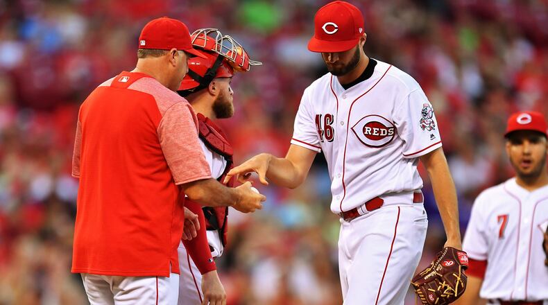 CINCINNATI, OH - JULY 14: Pitcher Tim Adleman #46 of the Cincinnati Reds hands the ball to manager Bryan Price #38 of the Cincinnati Reds after being pulled in the fifth inning against the Washington Nationals at Great American Ball Park on July 14, 2017 in Cincinnati, Ohio. Washington shut out Cincinnati 5-0. (Photo by Jamie Sabau/Getty Images)