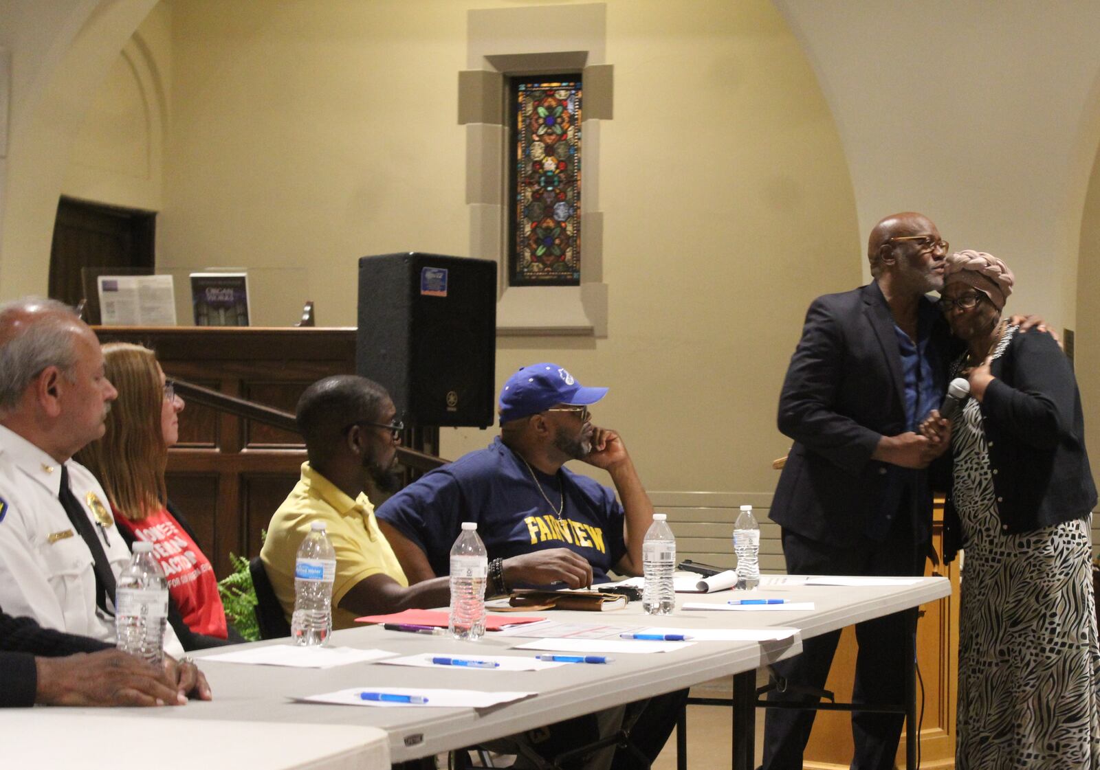 The Dayton Unit NAACP hosted a town hall focused on gun violence at Grace United Methodist Church on Monday, June 26, 2023.  Moderator Morris Brown hugs a member of the audience, Alberta Taylor, after she asked a question of the five-person panel. Guest panelists included Dayton police Chief Kamran Afzal; Susan Lane, with Moms Demand Action; Marlon Shackleford, a community activist; Julius Beckham, a psychologist; and David Fox, chair of criminal justice with the Dayton Unit. CORNELIUS FROLIK / STAFF