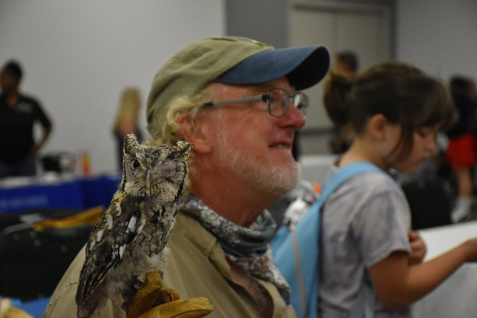 Douglas Horvath, education coordinator and naturalist at Five Rivers Metro Parks, holds “Juniper” the screech owl at a school supplies giveaway and resource fair for military and veteran families held Saturday, Aug. 9, 2025, near Wright-Patterson Air Force Base. CORNELIUS FROLIK / STAFF