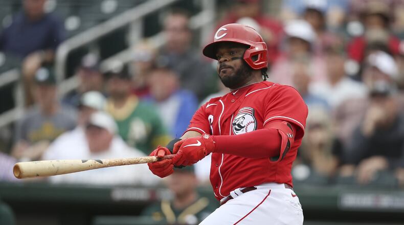 Cincinnati Reds’ Phillip Ervin (6) watches the flight of his run-scoring double against the Oakland Athletics during the third inning of a spring training baseball game Friday, Feb. 28, 2020, in Goodyear, Ariz. The Reds defeated the Athletics 10-1. (AP Photo/Ross D. Franklin)