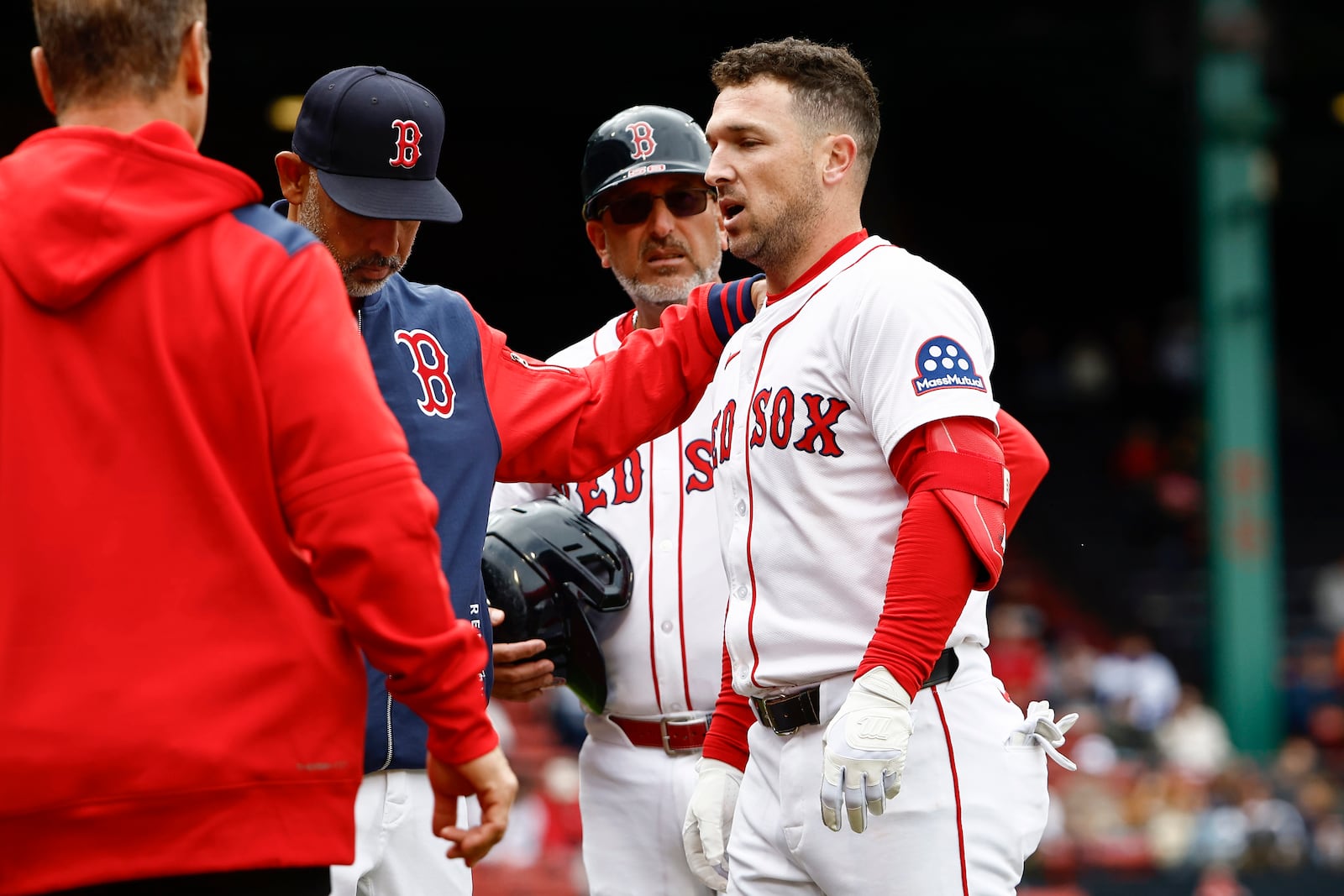 Boston Red Sox manager Alex Cora puts his hand on the shoulder of Alex Bregman as he leaves the game after injuring himself running out a single against the Baltimore Orioles during the fifth inning in the first baseball game of a doubleheader Friday, May 23, 2025, at Fenway Park in Boston. (AP Photo/Winslow Townson)