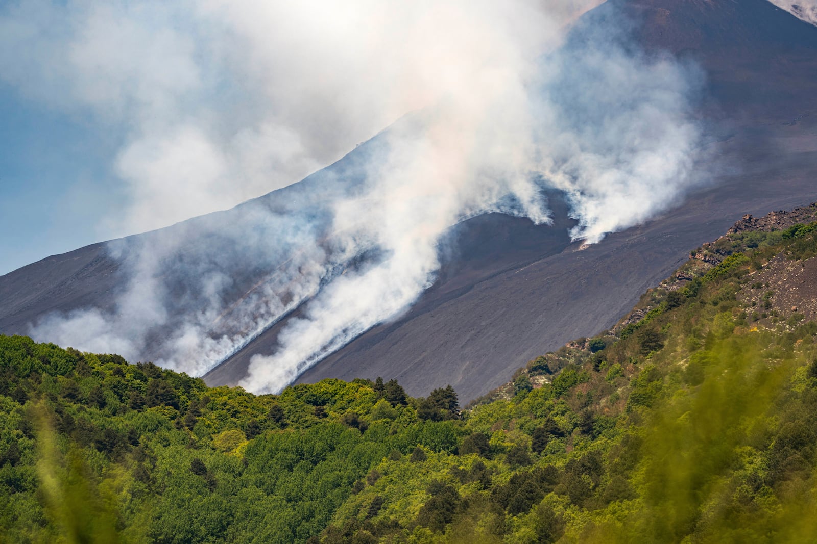 Smoke billows from Mount Etna volcano, Italy, Monday, June 2, 2025. (AP Photo/Giuseppe Distefano)