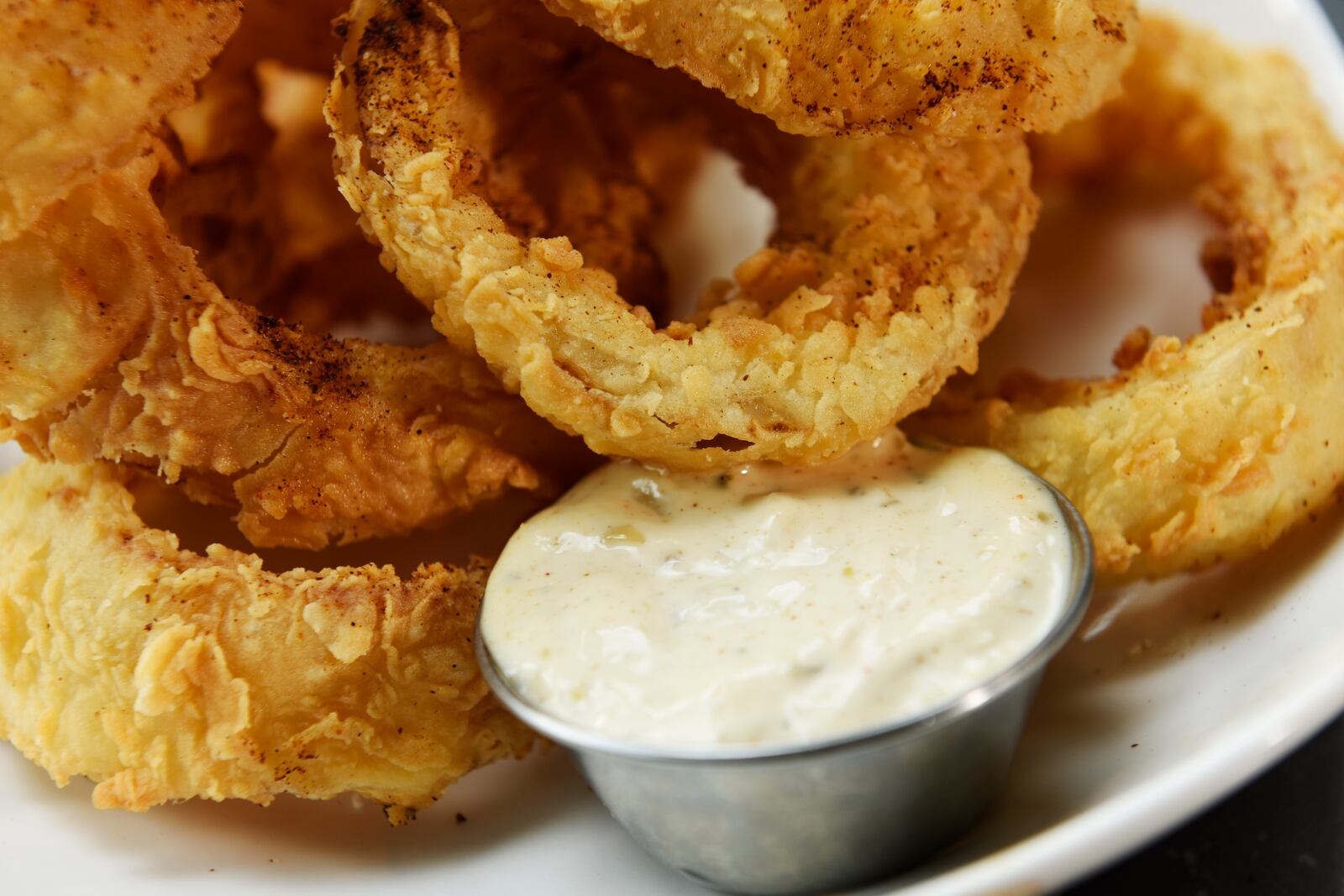 Flip Side will be one of the restaurants that will occupy the new Liberty Center development when it opens later this year in Liberty Twp. The restaurant has a location at Easton Town Center in Columbus, pictured.  This is the Crispy Flipside Onion Rings that are buttermilk battered with chile rubbed remoulade. NICK GRAHAM/STAFF