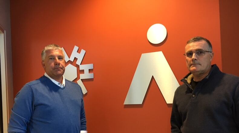 Bryan Bucklew, president and chief executive of the Greater Dayton Area Hospital Association, left, and Ricky Peters, CEO of Ascend Innovations, announced a new clinical research organization. THOMAS GNAU/STAFF