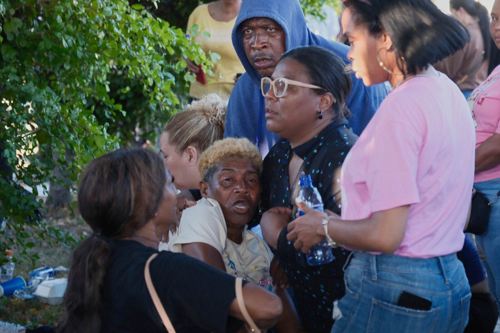 A relative of a missing person is comforted by friends outside Jet Set nightclub after its roof collapsed during a merengue concert in Santo Domingo, Dominican Republic, Tuesday, April 8, 2025. (AP Photo/Ricardo Hernandez)