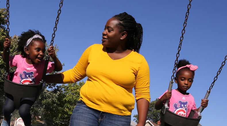 Cheree Moore enjoys an afternoon with twin daughters Auri, 3, left, and Camille at Longfellow Park on Sept. 12, 2016 in Oak Park, Ill. (Antonio Perez/Chicago Tribune/TNS)