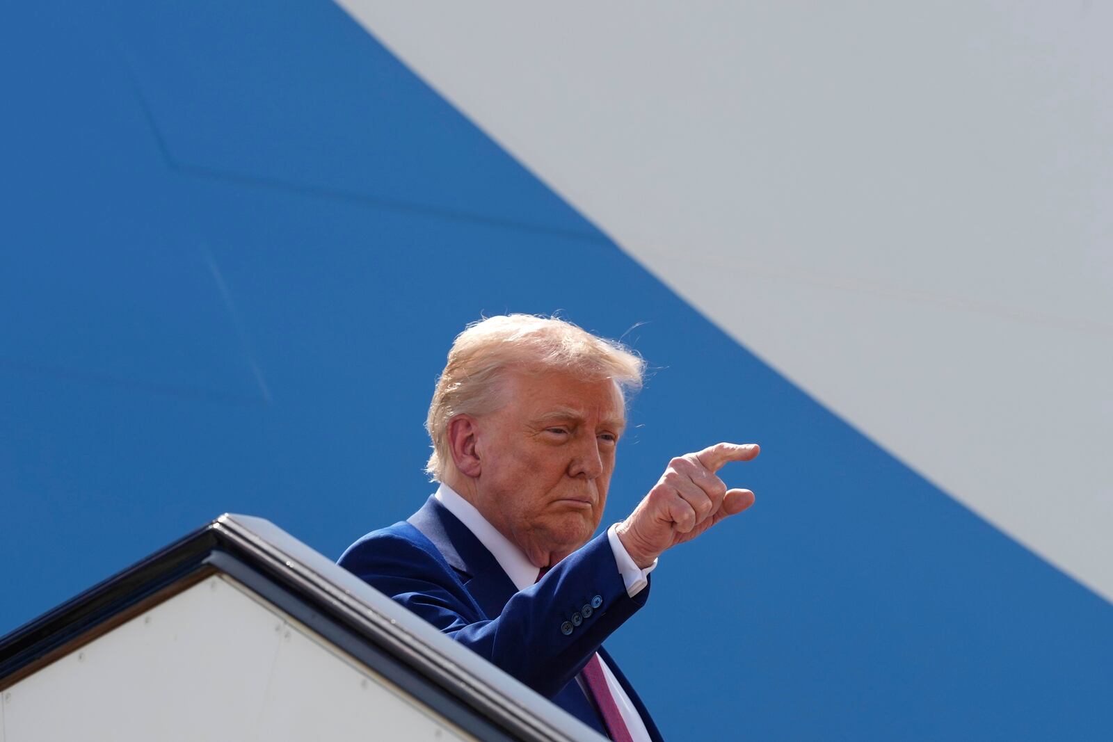 President Donald Trump gestures as he boards Air Force One to depart Al Udeid Air Base, Thursday, May 15, 2025, in Doha, Qatar. (AP Photo/Alex Brandon)