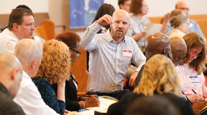 John Pyron, director of disaster response for Lutheran Social Services, speaks to a group working to set up a case management system to help Memorial Day tornado survivors with unmet needs. About 80 people gathered June 19, 2019, at St. Margaret’s Episcopal Church in Trotwood to plan long-term tornado recovery efforts. CHRIS STEWART / STAFF