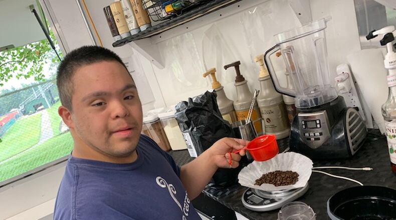 Coffee Caravan employee, Alex, making a coffee. CONTRIBUTED