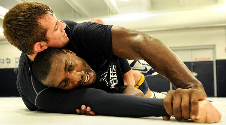 STATE COLLEGE, PA - NOVEMBER 07: UFC light heavyweight fighter Phil Davis works out with Penn State 165-weight senior wrestler David Taylor during the ‘20 days to UFC 167’ media tour at the Lorenzo Wrestling Complex on the campus of Penn State University on November 7, 2013 in State College, Pennsylvania. (Photo by Patrick Smith/Getty Images)