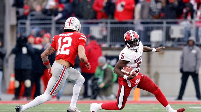 Indiana quarterback Dexter Williams, right, tries to get past Ohio State safety Lathan Ransom during the second half of an NCAA college football game Saturday, Nov. 12, 2022 in Columbus, Ohio. Ohio State won 56-14. (AP Photo/Paul Vernon)