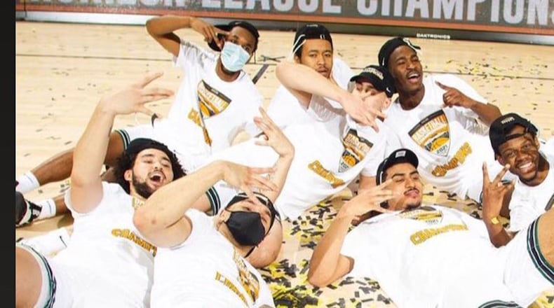 Torrey Patton (lying in front, second from right) and teammates celebrate on the confetti-strewn court at Indiana Farmers Coliseum after their Cleveland State Vikings beat Oakland Tuesday night to win the Horizon League Tournament and advance to the NCAA tournament. Patton scored a game high 23 points and had 10 rebounds. He was named the MVP of the Horizon League Tournament. (Contributed photo courtesy of Horizon League)