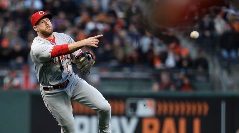 Cincinnati Reds shortstop Zack Cozart makes an off-balance throw to first base to put out San Francisco Giants’ Eduardo Nunez after a ground ball during the second inning of a baseball game Friday, May 12, 2017, in San Francisco. (AP Photo/Marcio Jose Sanchez)