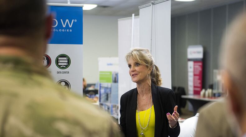 Kimberly Kempa, AppDynamics sales executive, talks with members of the Wright-Patterson Air Force Base, community April 3 as part of the Wright-Patterson Tech Expo. The expo, sponsored by the Air Force Materiel Command and the Air Force Life Cycle Management Center, brought representatives of 30 companies together to display their news technologies and procedures. (U.S. Air Force photo/R.J. Oriez)
