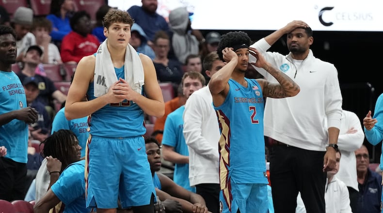 Florida State forward Alex Steen, left, and guard Cam Miles (2) watch from the sideline during the second half of an NCAA college basketball game against Massachusetts at the Orange Bowl Basketball Classic, Saturday, Dec. 13, 2025, in Sunrise, Fla. (AP Photo/Lynne Sladky)