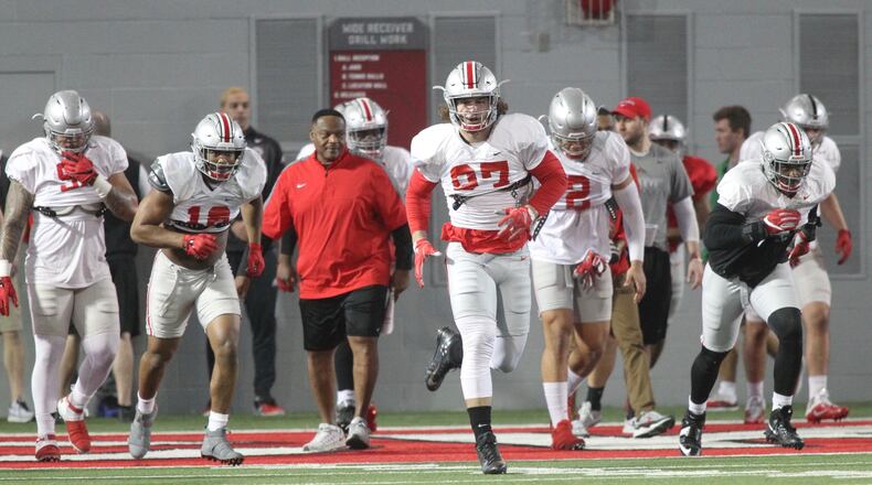 Ohio State players, including Nick Bosa (97) warm up before practice on Monday, March 26, 2018, at the Woody Hayes Athletic Center in Columbus. David Jablonski/Staff