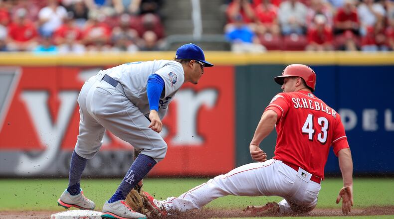 CINCINNATI, OH - SEPTEMBER 12: Manny Machado #8 of the Los Angeles Dodgers tags out Scott Schebler #43 of the Cincinnati Reds as he attempted to steal second base in the first inning at Great American Ball Park on September 12, 2018 in Cincinnati, Ohio.  (Photo by Andy Lyons/Getty Images)