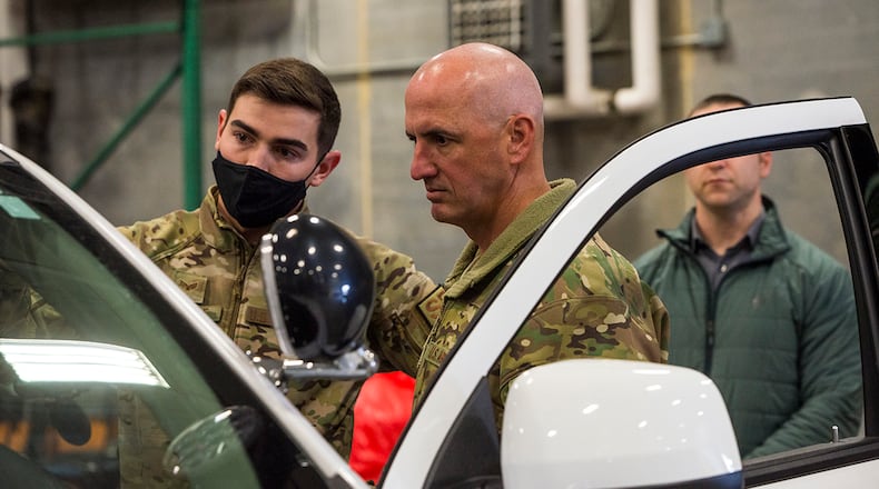 Chief Master Sgt. David Flosi (center), Air Force Materiel Command command chief, listens as Senior Airman Paiden Carlisle, 88th Security Forces Squadron vehicle control officer, describes how unit capabilities can integrate with future technology such as the android tactical assault kit on March 10 at Wright-Patterson Air Force Base. ATAK enhances command and control during emergency situations and allows for multiagency integration. U.S. AIR FORCE PHOTO/JAIMA FOGG