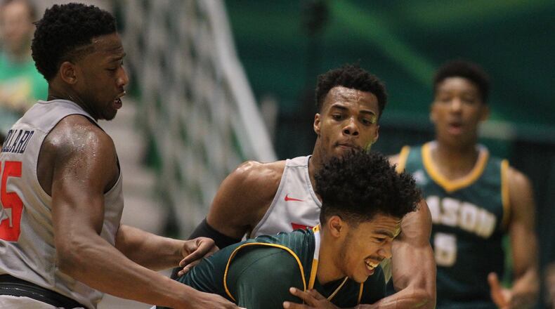 Dayton’s Kendall Pollard, left, and Charles Cooke, back center, trap George Mason’s Otis Livingston II on Saturday, Feb. 6, 2016, at EagleBank Arena in Fairfax, Va. David Jablonski/Staff
