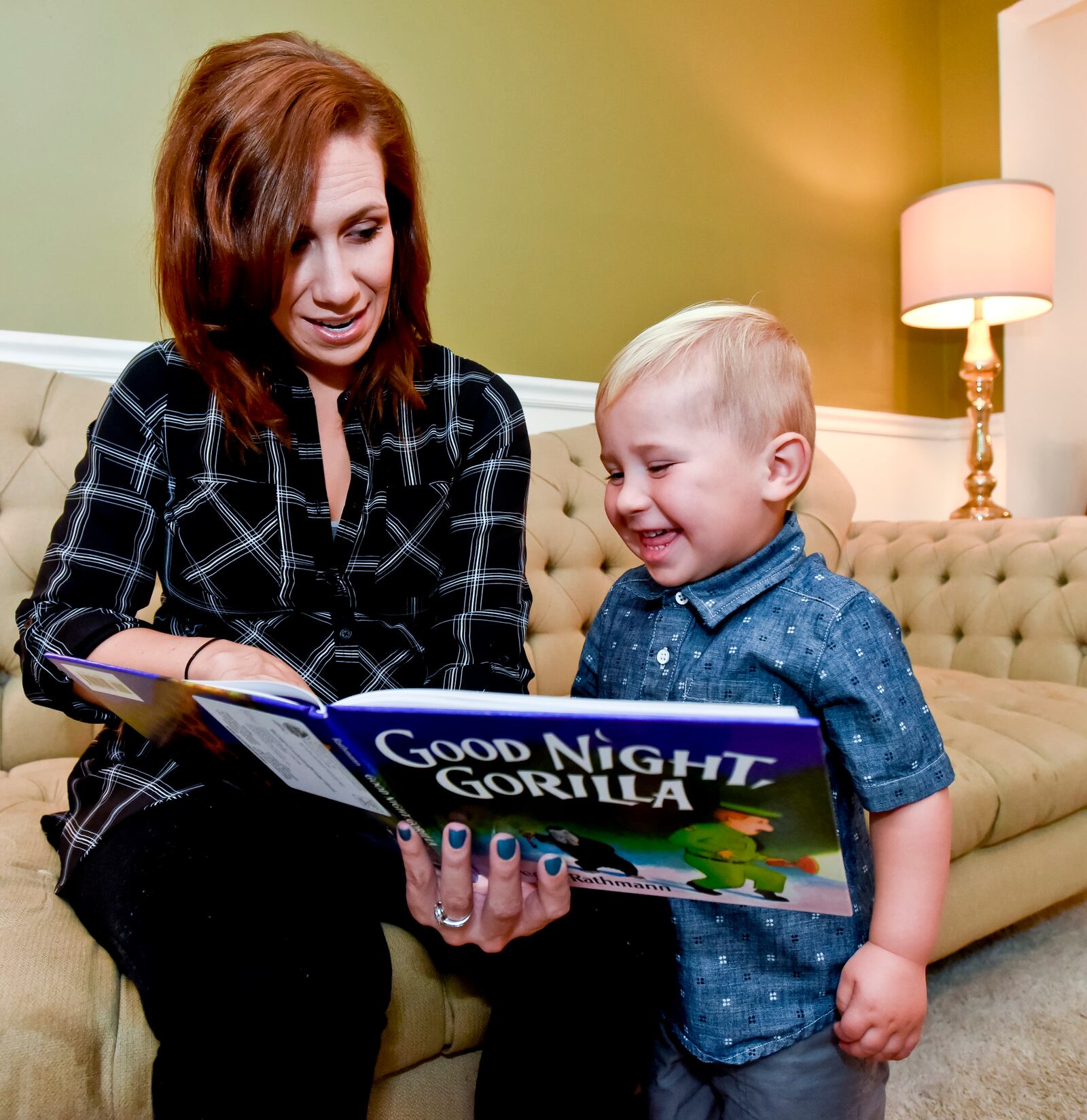 Sara Flynn reads a book from the Dolly Parton Imagination Library to her son Theo, 2, Wednesday, Nov. 4 at her home in Middletown. Flynn says she reads daily to her son and has been receiving books through the Dolly Parton Imagination Library program since Theo was six months old. The program is an early childhood literacy program that provides one free, age-appropriate, expert-selected book every month to any child birth to age 5 living within the borders of the Edgewood, Franklin, Madison, Monroe, Trenton, and Middletown School Districts. The books are a gift to all of our community's children who sign up for the program thanks to the financial support of the Middletown Community Foundation. NICK GRAHAM/STAFF