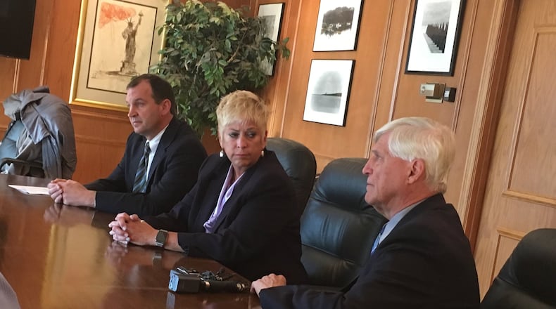 Dayton Public Schools Superintendent Rhonda Corr (center) listens as attorney David Duwel (right) discusses allegations against Corr at a press conference Wednesday, Nov. 29, 2017. Attorney Jon Paul Rion is at left. JEREMY P. KELLEY / STAFF