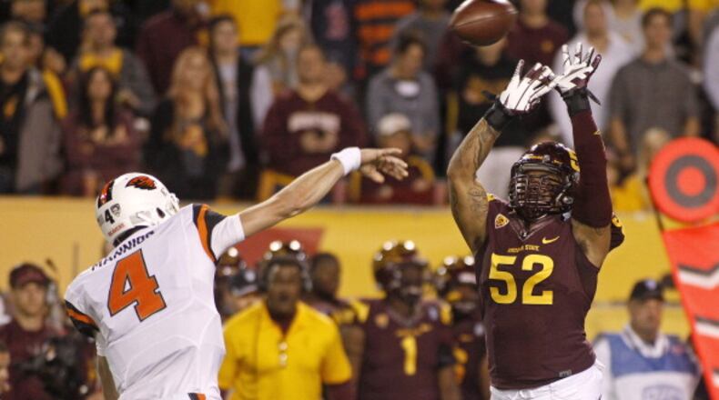 TEMPE, AZ - NOVEMBER 16: Quarterback Sean Mannion #4 of the Oregon State Beavers throws a pass as he is pressured by linebacker Carl Bradford #52 of the Arizona State Sun Devils during the first quarter of their college football game at Sun Devil Stadium on November 16, 2013 in Tempe, Arizona. (Photo by Ralph Freso/Getty Images)