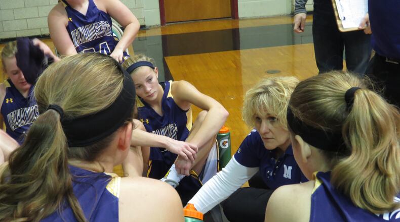 Mechanicsburg coach Christie Dodane talks things over with her team during a break. KERMIT ROWE / CONTRIBUTED