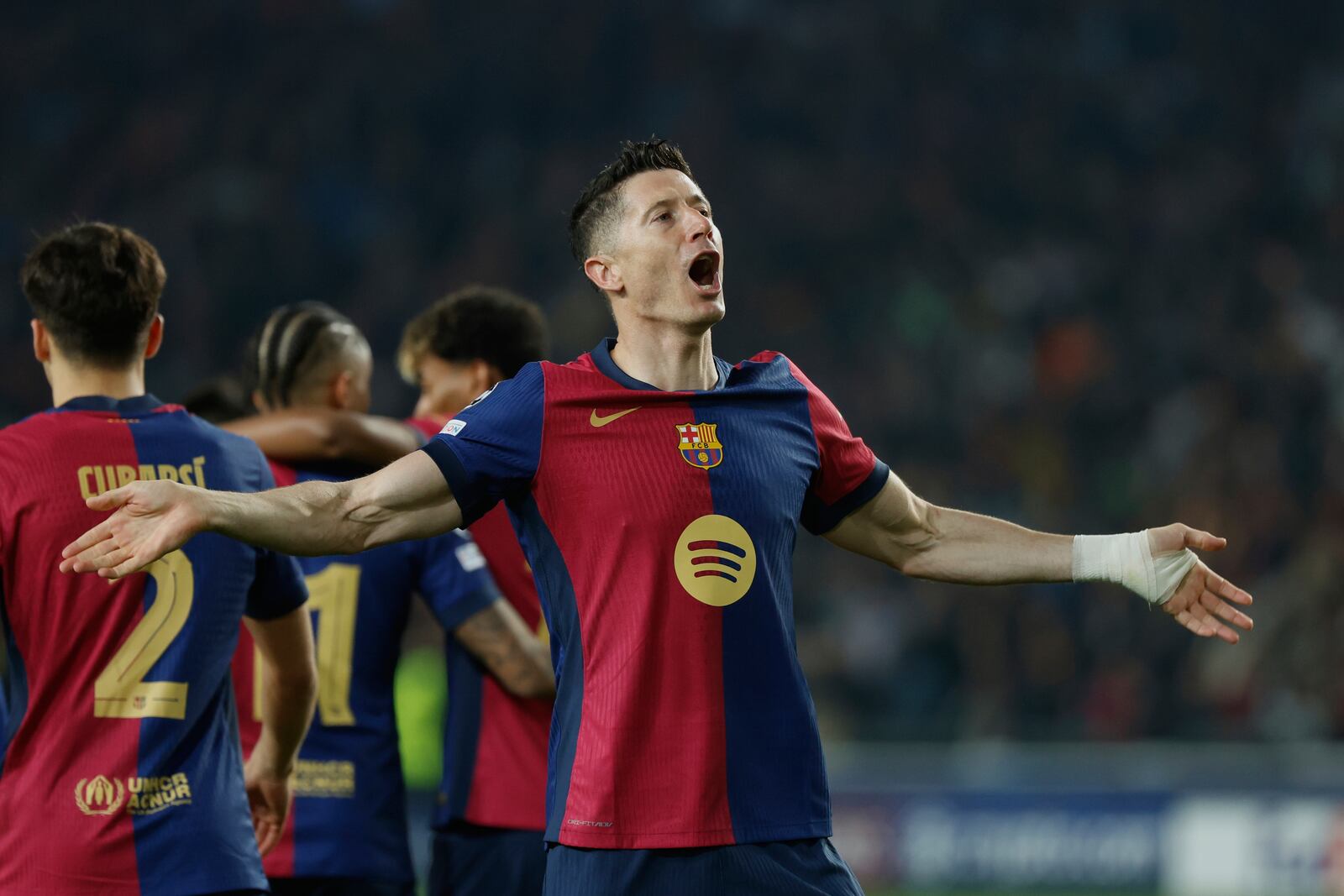 Barcelona's Robert Lewandowski celebrates after scoring his side's second goal during the Champions League quarterfinals first leg soccer match between Barcelona and Borussia Dortmund, at the Lluis Companys Olympic stadium in Barcelona, Spain, Wednesday, April 9, 2025. (AP Photo/Joan Monfort)