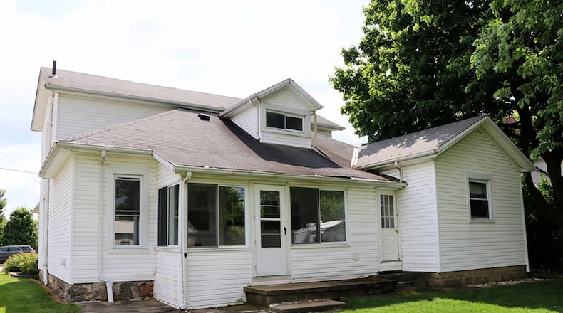 The house is located on the main roadway within Pitsburg and is on a double lot which includes a 1-car, detached garage and storage shed.