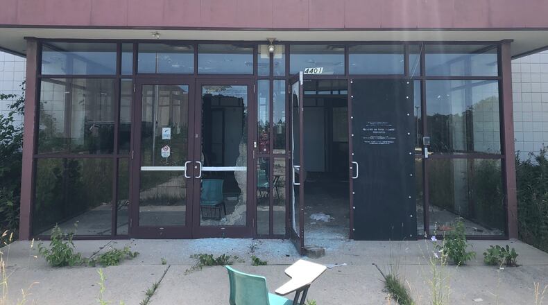 Doors and windows are broken at the long-closed Watkins Academy school at 4401 Dayton-Liberty Road on June 16, 2021. JEREMY P. KELLEY/STAFF