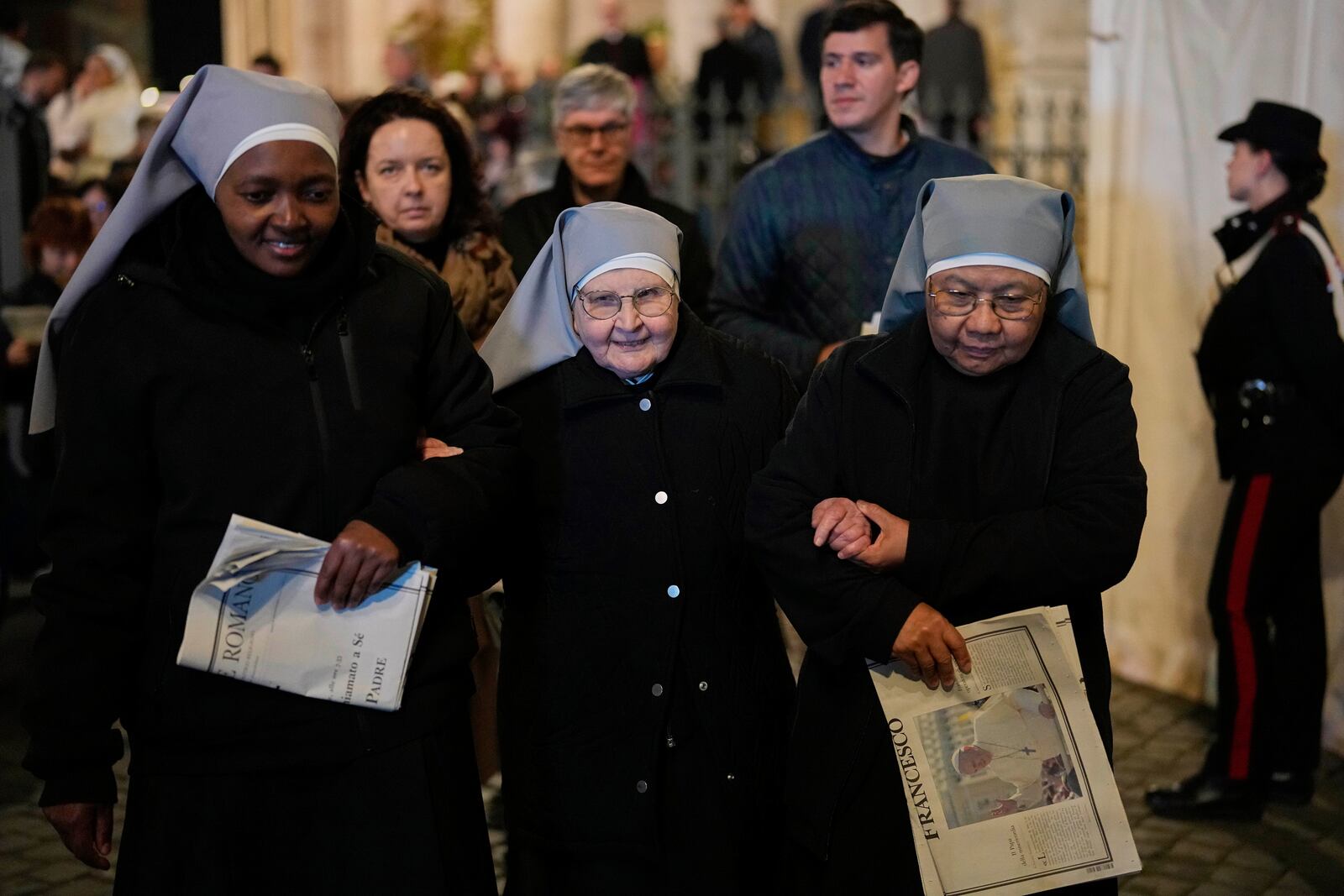 Nuns support each other as they leave after attending a rosary prayer outside the Santa Maria Maggiore Basilica, where the late Pope Francis will be buried, in Rome, Thursday, April 24, 2025. (AP Photo/Andreea Alexandru)