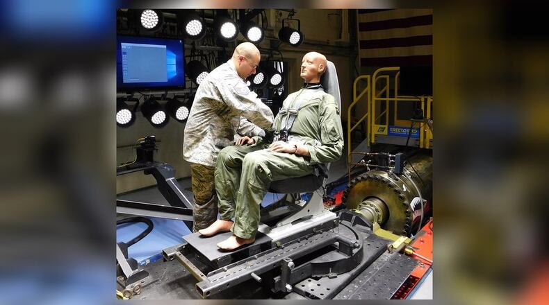 Master Sgt. James Chase of Air Force Research Laboratory’s 711th Human Performance Wing Biodynamics team prepares an instrumented 250-pound test device, simulating a human occupant, for seat testing on the Horizontal Impulse Accelerator, located at Wright-Patterson Air Force Base. The test is one of a series recently conducted to support the acceptance and implementation of the Portable Biocontainment Care Module, which will aid in the safe transport of personnel affected by infectious diseases, including COVID-19. (Courtesy photo/Infoscitex Corp., Christopher Albery)