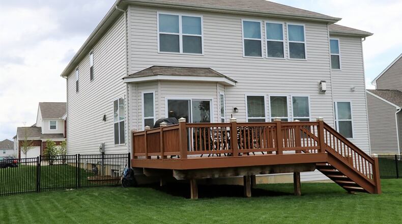 Patio doors open off the breakfast room to the rear deck and fenced back yard.