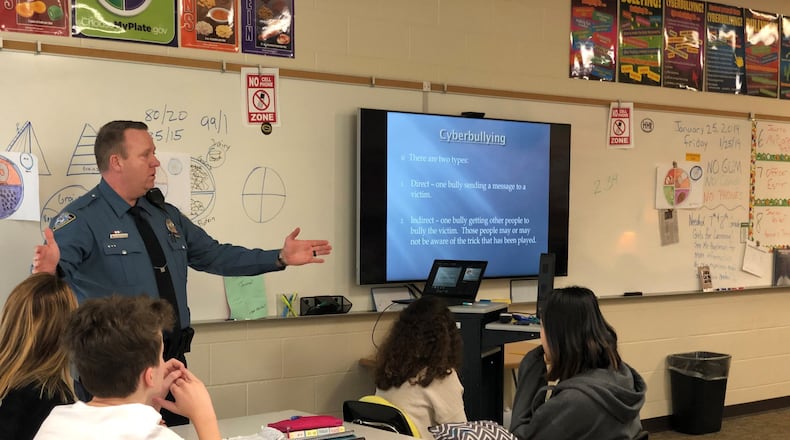 Centerville Police Department officer Brad Eshler talks with students at Tower Heights Middle School about internet safety and social media. CONTRIBUTED