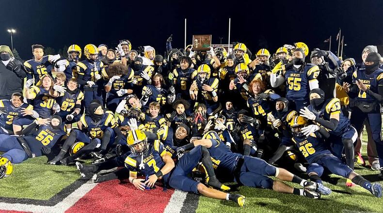 The Springfield High School football team poses for a photo with the Division I, Region 2 championship trophy after defeating Olentangy Liberty 35-7 on Friday night at London's Bowlus Field. CONTRIBUTED PHOTO BY MICHAEL COOPER