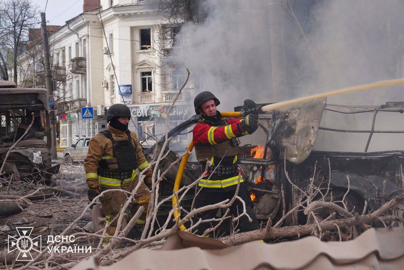 In this photo provided by the Ukrainian Emergency Service, firefighters put out the fire following Russia's missile attack that killed at least 20 civilians in Sumy, Ukraine, Sunday, April 13, 2025. (Ukrainian Emergency Service via AP)