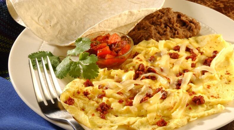 Spicy heat from chorizo and chili powder contrast with the creamy eggs and cheese. A white wine with good acidity matches with all those elements. (James F. Quinn/Chicago Tribune/TNS)